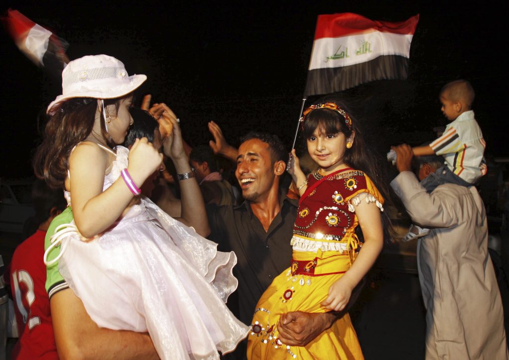 Iraqis celebrate in Basra, Iraq's second-largest city, 550 kilometers (340 miles) southeast of Baghdad, Iraq, Tuesday, June 30, 2009. U.S. troops pulled out of Iraqi cities on Tuesday in the first step toward winding down the American war effort by the end of 2011. (AP Photo/Nabil al-Jurani)
